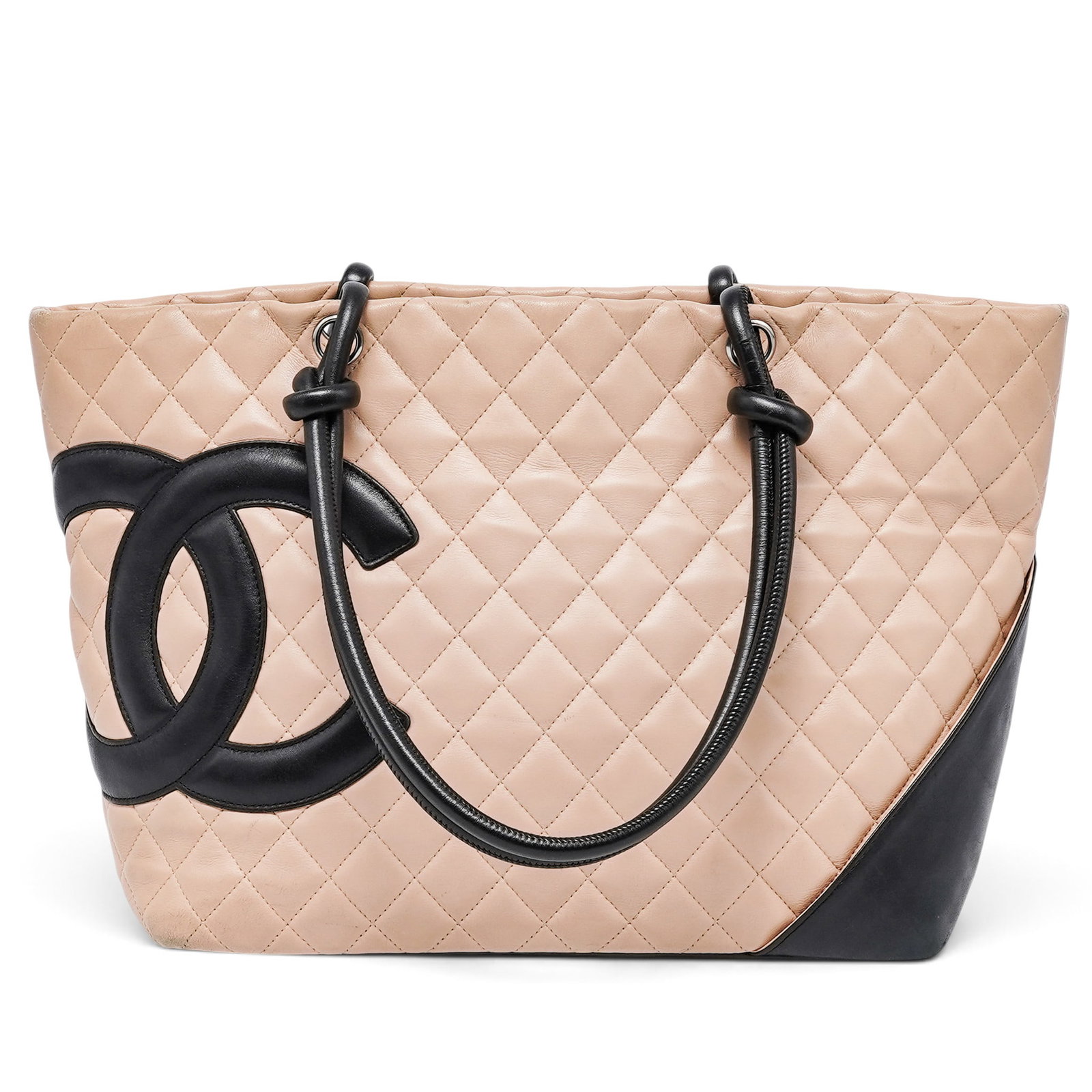 Chanel "Cambon" Tote Quilted Beige Lambskin Leather: Chanel "Cambon" Tote Quilted Beige Lambskin Leather 2005, France The Chanel Cambon Tote is crafted from soft quilted beige lambskin, accented by the signature oversized black CC logo and silver-tone