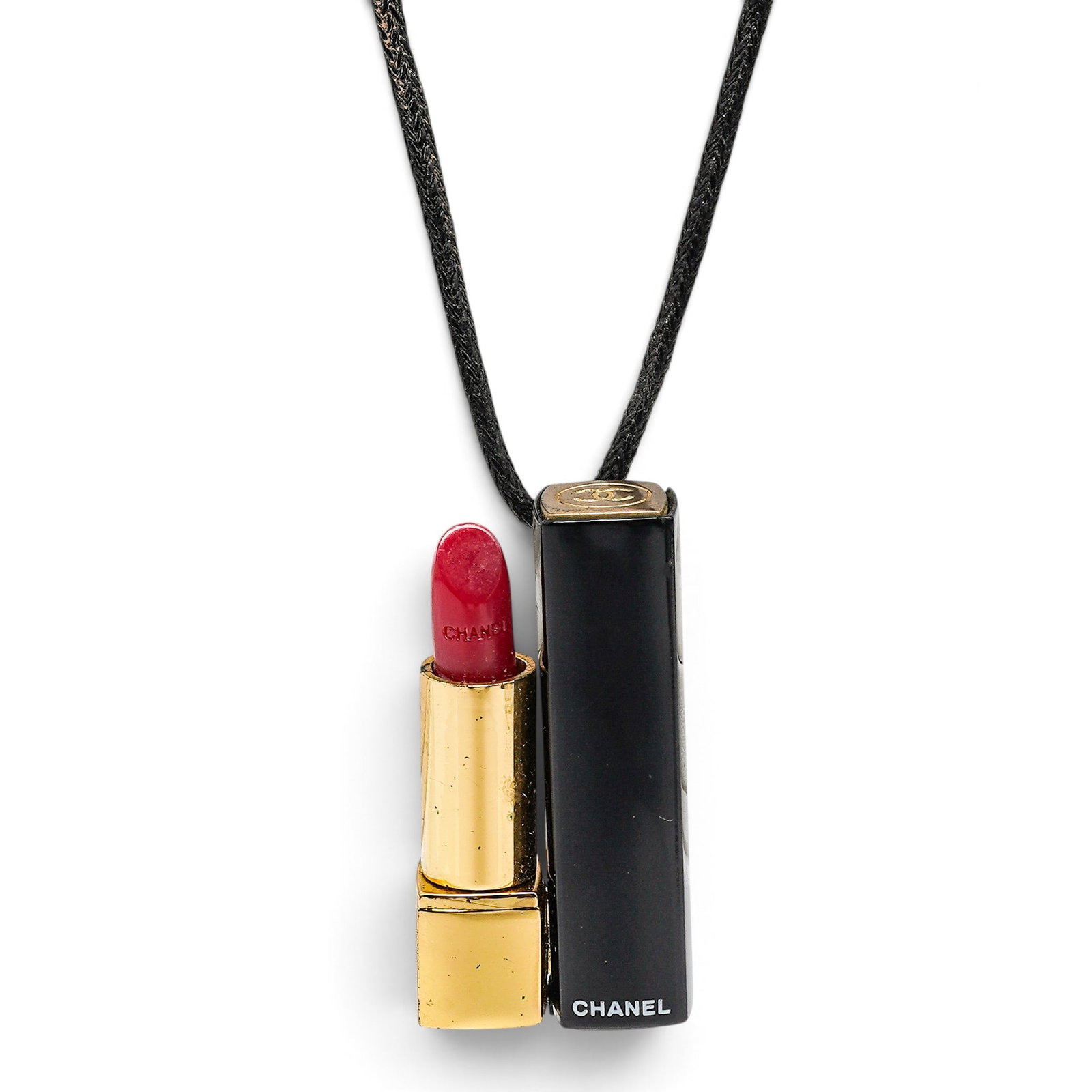 Chanel Lipstick Pendant Necklace: Chanel Lipstick Pendant Necklace 1990, France Chanel Lipstick Pendant Necklace featuring a lipstick-inspired pendant in gold-tone metal with black and red enamel, hung from a cotton-silk cord necklace
