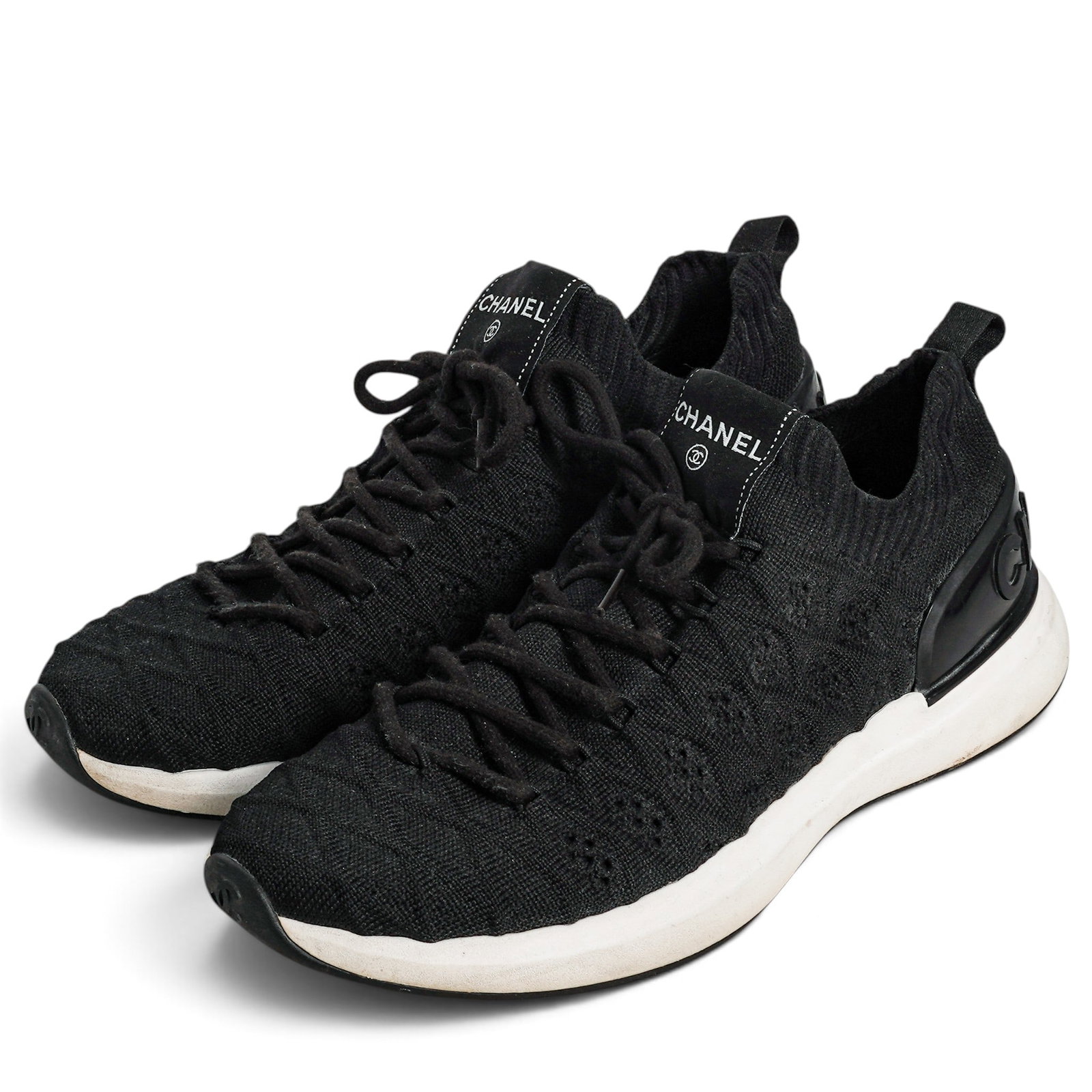 Chanel Black Knit Logo Sneakers: Chanel Black Knit Logo Sneakers 2020's, Italy Chanel Black Knit Logo Sneakers featuring a breathable textured black upper and a contrasting white rubber sole. Retail Cost: $1,200 Size 38, (US 8)