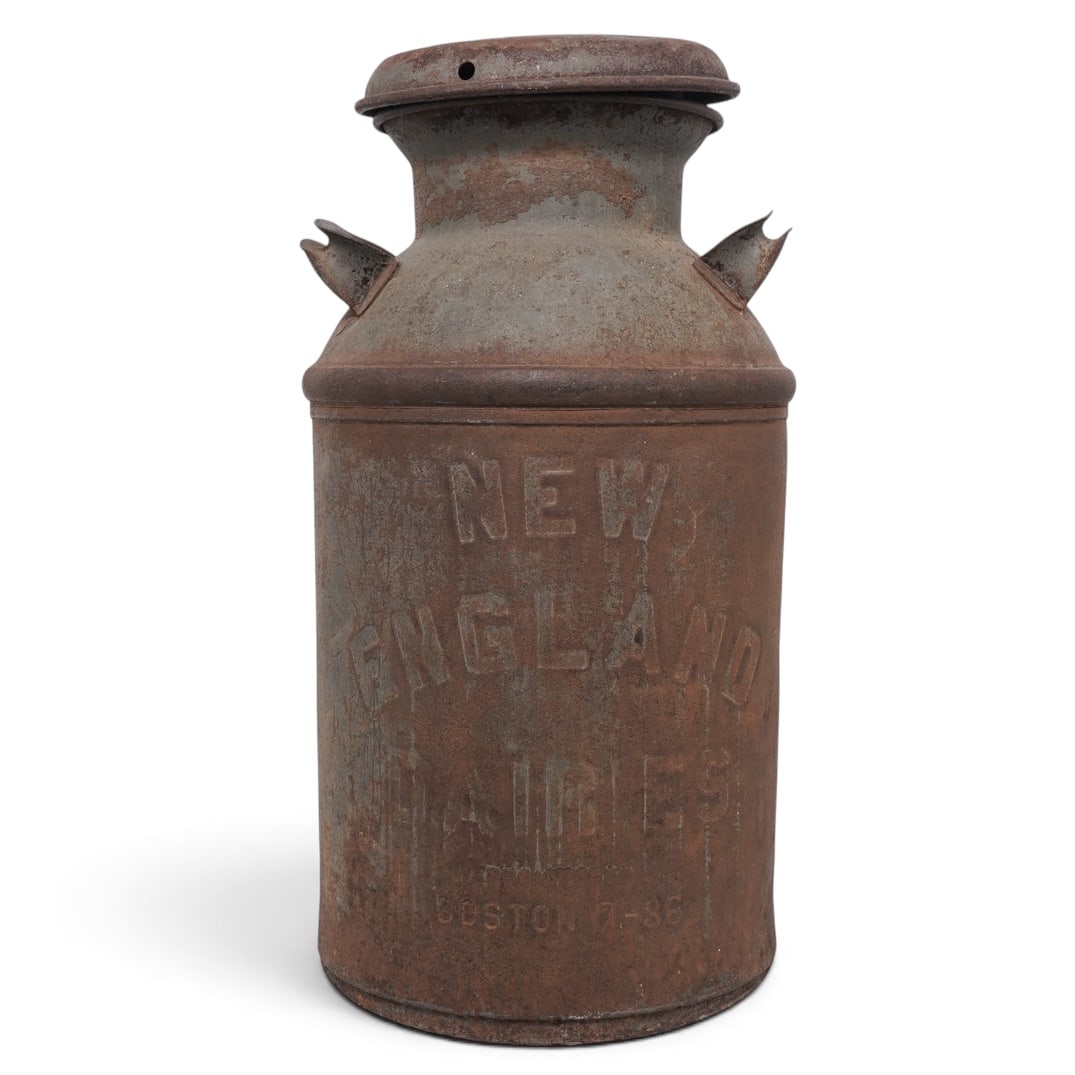Antique New England 10-Gallon Metal Milk Jug: Antique New England 10-Gallon Metal Milk Jug Early 20th Century, USA A large cylindrical metal milk can with domed shoulder, fitted lid, paired side handles, and embossed “NEW ENGLAND DAIRIES /