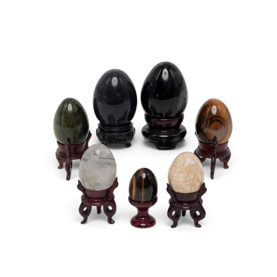 (7 pc) Grouping of Semi Precious Stone Eggs w/ Stands: (7 pc) Grouping of Semi Precious Stone Eggs w/ Stands Mid-Late 20th Century Artist/Designer/Manufacturer: Unknown. Marking(s): None. Materials: Serpentine, brecciated jasper, tiger’s eye,