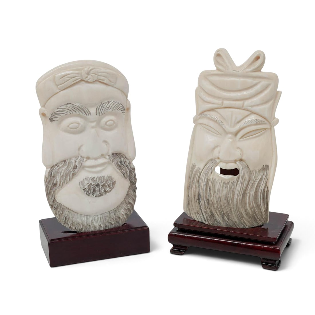 (2pc) East Asian Carved Bone Heads w/ Stands: (2pc) East Asian Carved Bone Heads w/ Stands 20th Cent. East Asian Artist/Designer/Manufacturer: Unknown. Marking(s): notes: None. Materials: Carved bone & wood. Cataloger Note: Pair of hand-carved wa