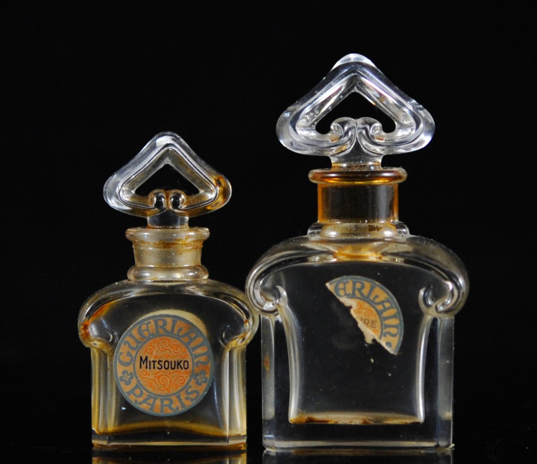 Pair of Bacarrat "Guerlain" vintage perfume bottles: DESCRIPTION: Pair of Bacarrat "Guerlain" vintage perfume bottles. Both with clear beveled glass bodies, tam horn style top and spade designed stoppers. Large bottle marked "Guerlain Bacarrat Made in F
