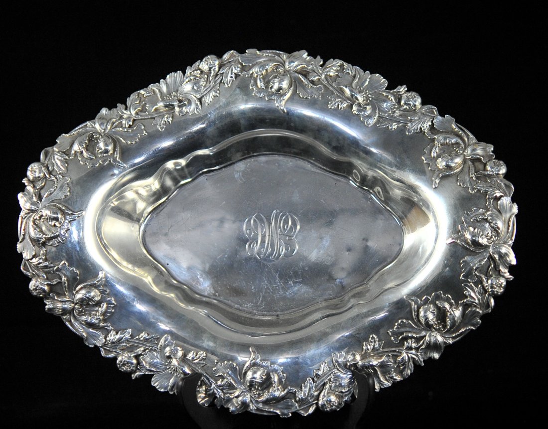 Antique Sterling Silver Repousse Bowl: DESCRIPTION: Sterling silver repousse bowl with a baroque floral design on the border. Initialed in script "EMC" and stamped "Sterling 133". Weighs 700grams. CIRCA: 19/20th ct ORIGIN: USA DIMENSIONS: 