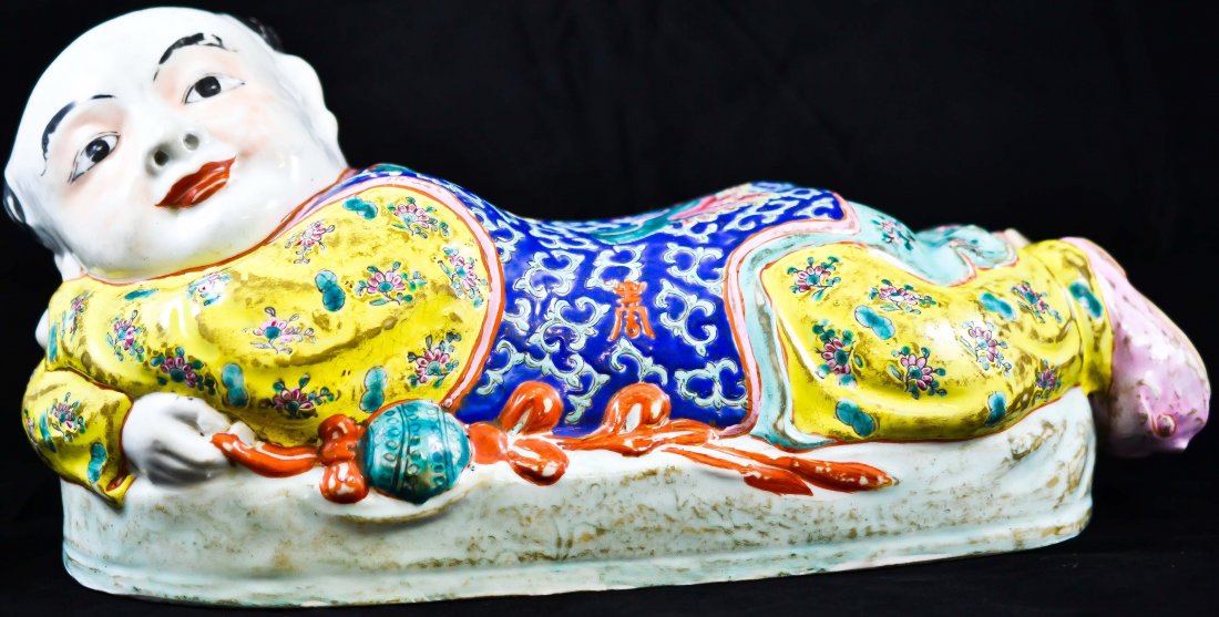 Chinese Republic hand painted porcelain pillow: DESCRIPTION: Chinese Republic hand painted porcelain pillow of a child laying down with mixed colors, 2 foo dogs on his back and a floral motif. Chinese characters on each sides. CIRCA: 1920s MADE IN: