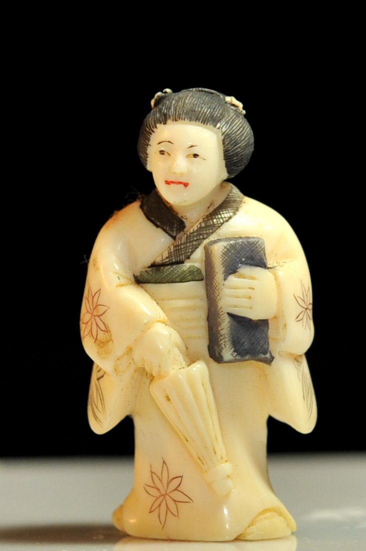 Vintage Chinese Geisha ivory carving. Signed: DESCRIPTION: Vintage Chinese Geisha ivory carving. She stands diligently holding a book under one are and an umbrella in the other. Polychrome robe engravings throughout. Mint CIRCA: Mid to late 20th 