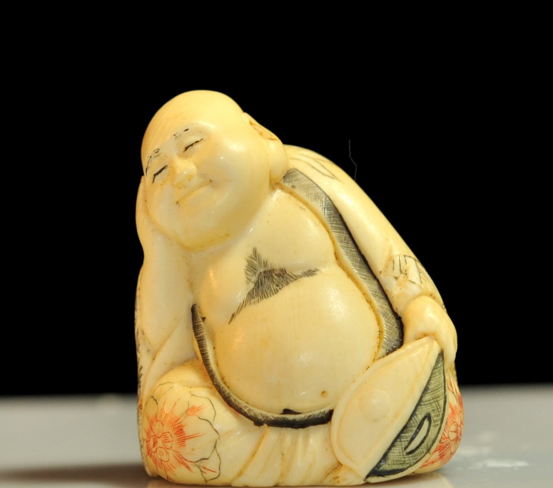 Antique Chinese ivory figural Buddha netsuke: DESCRIPTION: 19th Century Chinese ivory figural Buddha netsuke. Depiction of the Buddha with his hand on his cheek resting. He dons an engraved polychrome robe with floral decoration. Mint condition. 