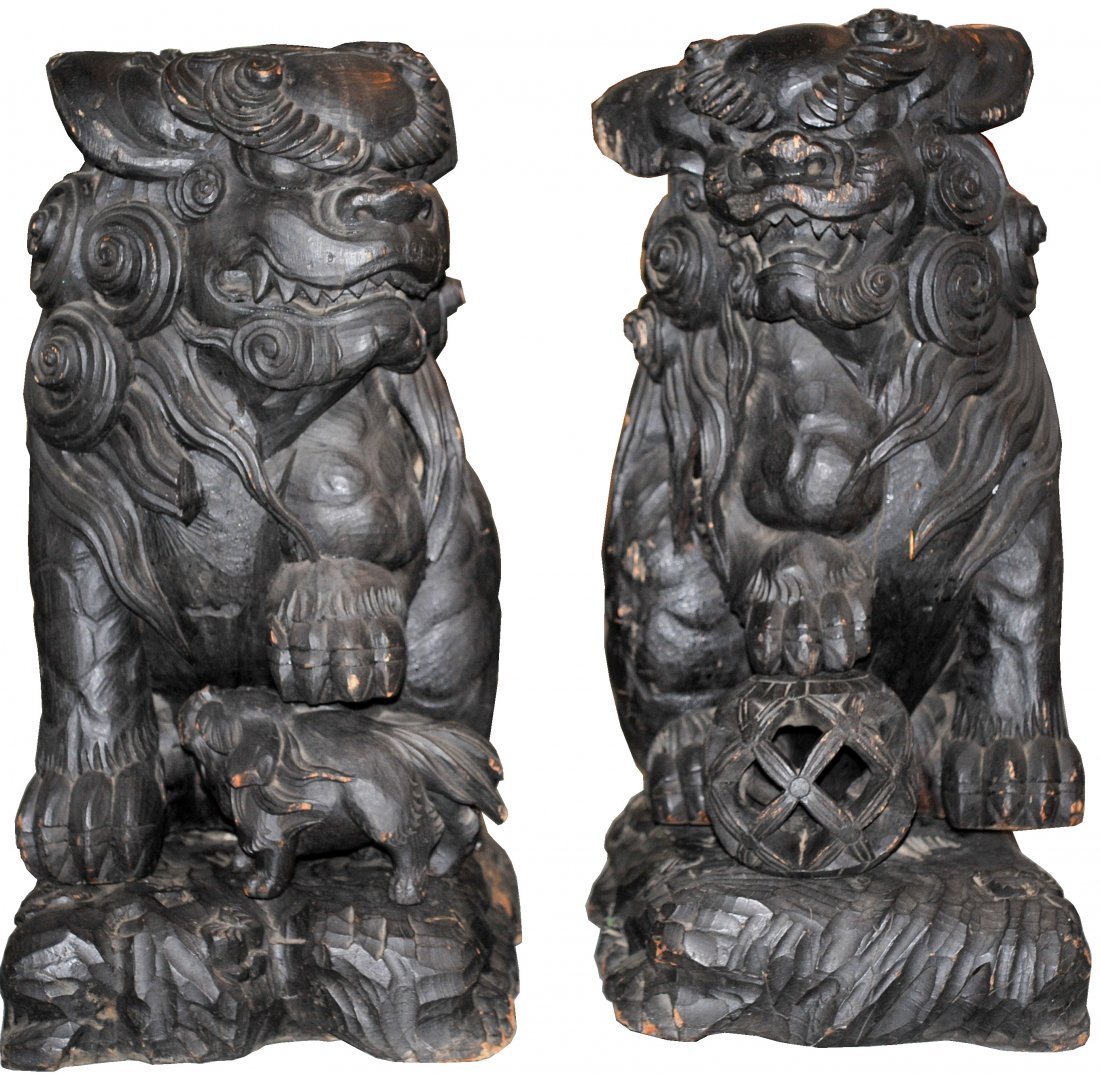 Pair of 19th Century Life Size Foo dogs: DESCRIPTION: Pair of 19th Century large hand carved foo dogs. Sublime pair of gigantic rose wood hand carved foo dogs on bases. Each one has a short squat body design with each one looking off to the 
