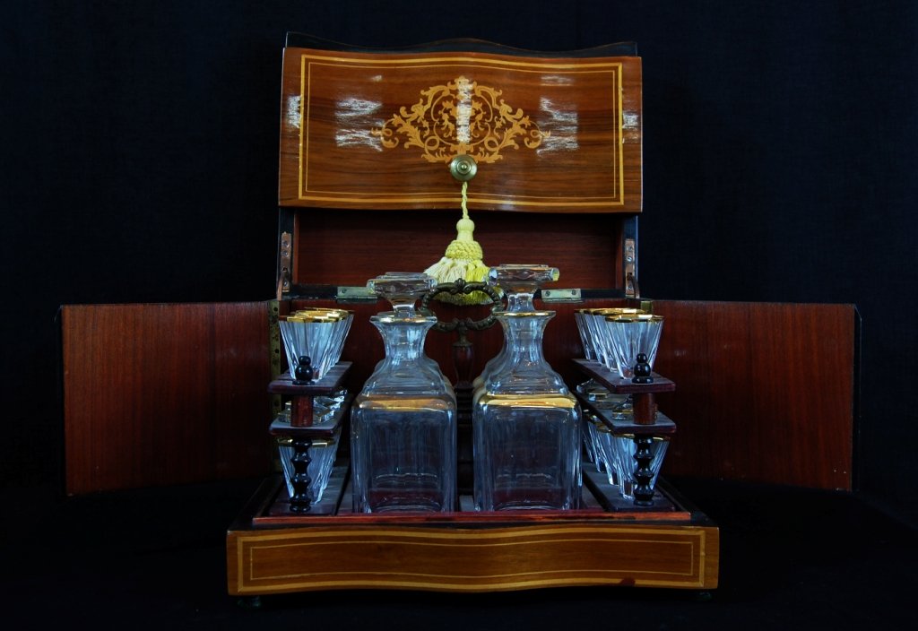 Art nouveau French liquor box: DESCRIPTION: Art nouveau French liquor box made out of mahogany wood, decanters and shot glasses made out of crystal. Comes with original key. CIRCA: 1910s Origin: France