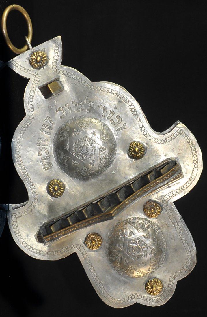 19th Cent. Wall Hanging Menorah: DESCRIPTION: Antique wall hanging Menorah in the shape of a Hamsa, made of brass with a coat of silver on the front panel and the back panel. All baroque with the star of David. CIRCA: 19th ct. ORIGIN