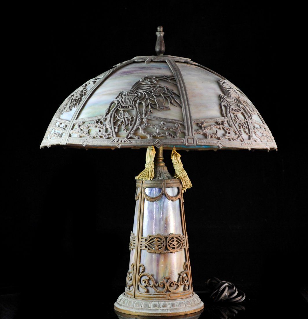 Antique Art Noveu Table Lamp: DESCRIPTION: Art Noveu six panel table lamp with multicolored slag glass. Lamp is standing on a metal base that also features same slag glass panels. CIRCA: Early 1900s ORIGIN: U.S.A DIMENSIONS: H: 22