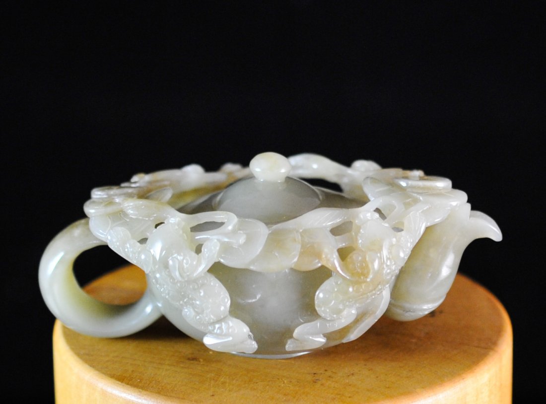 Chinese Hand Carved Jade Tea Pot: DESCRIPTION: Chinese hand carved jade tea pot. Features a band carved with a floral motif and mythical beasts. Jade is of a darker green shade, includes a removable lid. Detail is phenomenal. Mint ORI