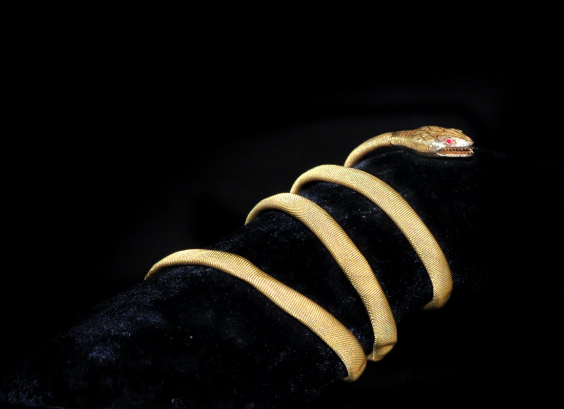 Art Deco 18k Gold Winding Snake Ladies Bracelet: DESCRIPTION: Antique 18k Gold snake winding bracelet with ruby eyes, unique twisted wire design,the head has been ornamented with engravings corresponding to reptile-like scales, almost inaudible hiss