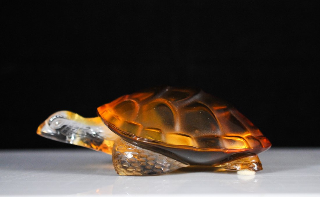 Lalique Crystal Amber Turtle Figure "Caroline": DESCRIPTION: Lalique rich amber turtle "Caroline" paperweight figure, signed bottom "Lalique France" CIRCA: 20th Century ORIGIN: France DIMENSIONS: L: 6" W: 4"