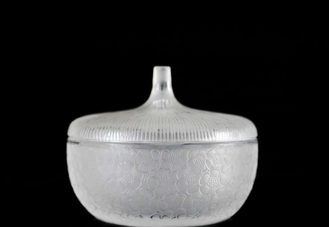 Lalique lidded art glass dish: DESCRIPTION: Lalique lidded art glass dish. The bowl molded in low relief with flowers and acorn-top lid with radiating lines. Engraved Lalique France. CIRCA: 20th ct ORIGIN: France DIMENSIONS: H: 5.5