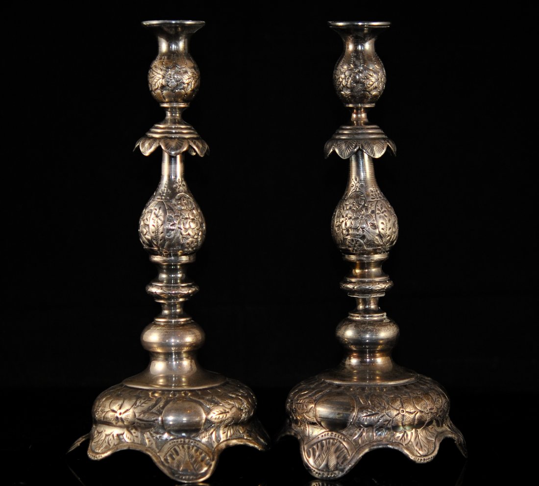Pair Russian Antique Silver Candle sticks: DESCRIPTION: Pair of Russian silver candle sticks. Beautiful full top to bottom floral repousse decoration in very crisp and sharp relief. Weigh a total of 800 grams. Each candelabra is traditionally
