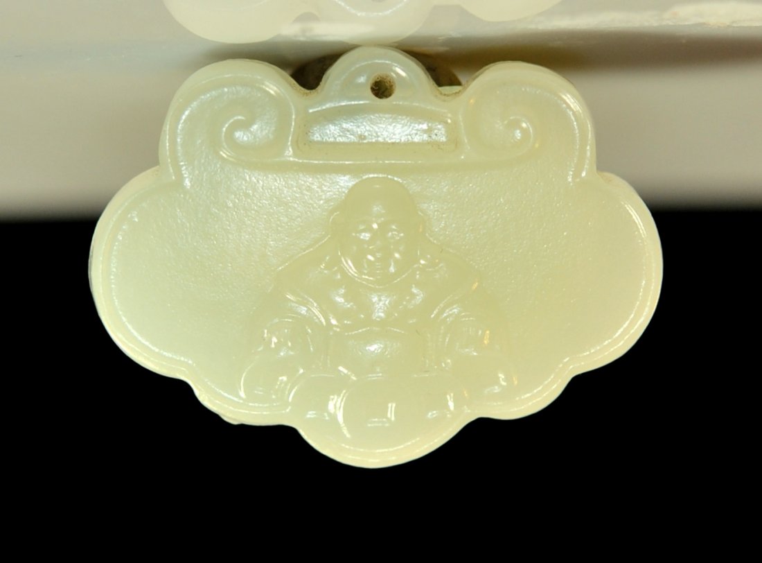 Early Chinese hand carved jade "Buddha" plaque: DESCRIPTION: Early Chinese hand carved jade "Buddha plaque". Hand carved white jade with a cloud body design. Features a raised Buddha sitting at meditation on the front side with the reverse being sm