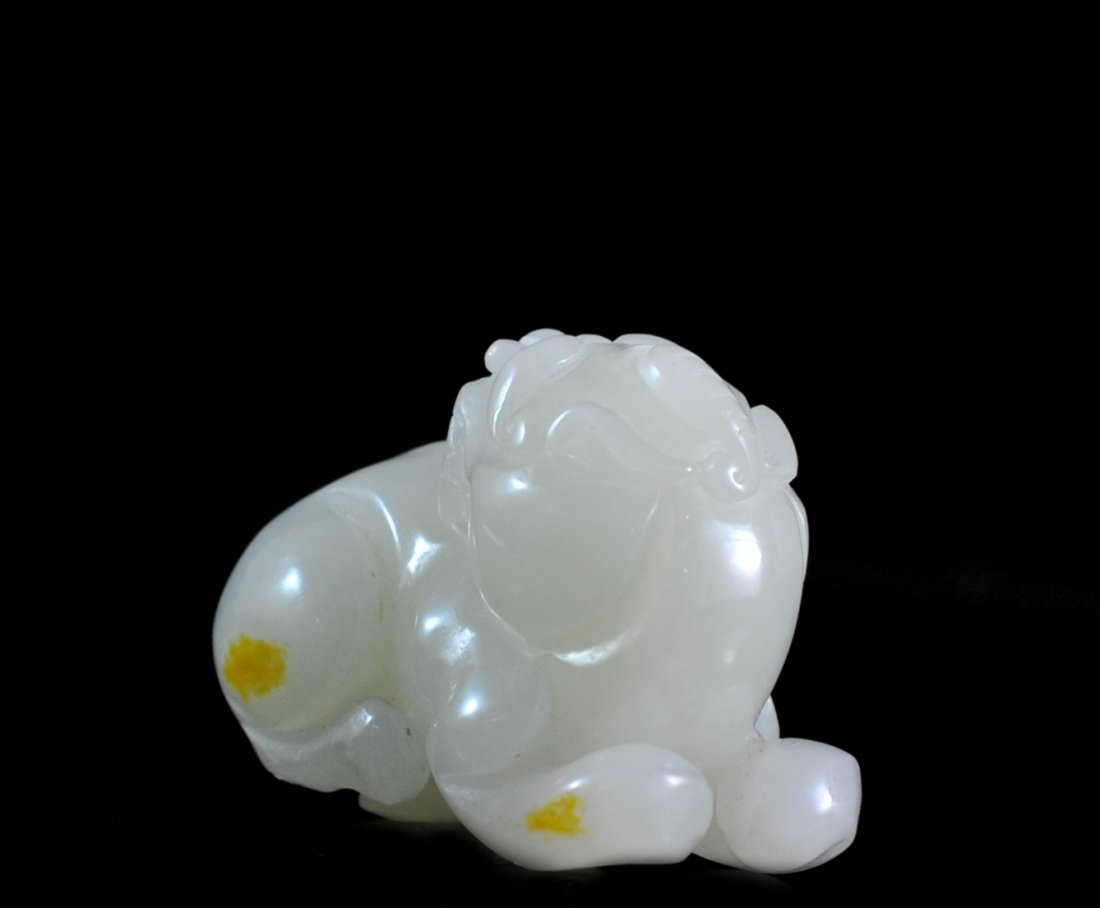 Chinese Hand Carved White Jade Foo Dog: DESCRIPTION: Hand carved white jade foo dog. Features the classic foo dog figure with its head turned facing back. Exceptional carving with great detail on facial features. Couple of spots of golden b