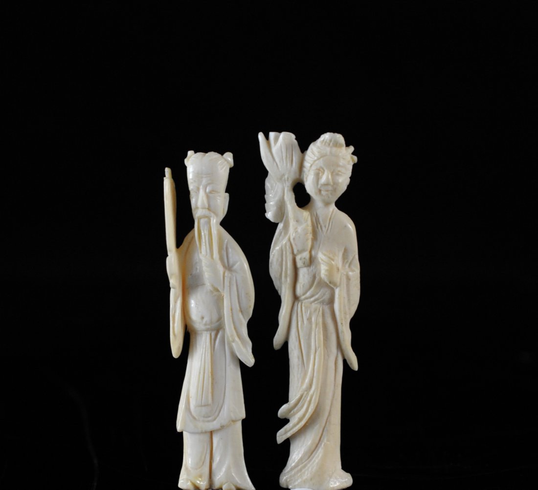 Two Chinese Hand Carved Ivory Figurines: DESCRIPTION: Lot of 2 antique ivory figurines, older gentlemen holding a fan and lady holding flowers CIRCA: 1900s ORIGIN: China DIMENSIONS: H:3"