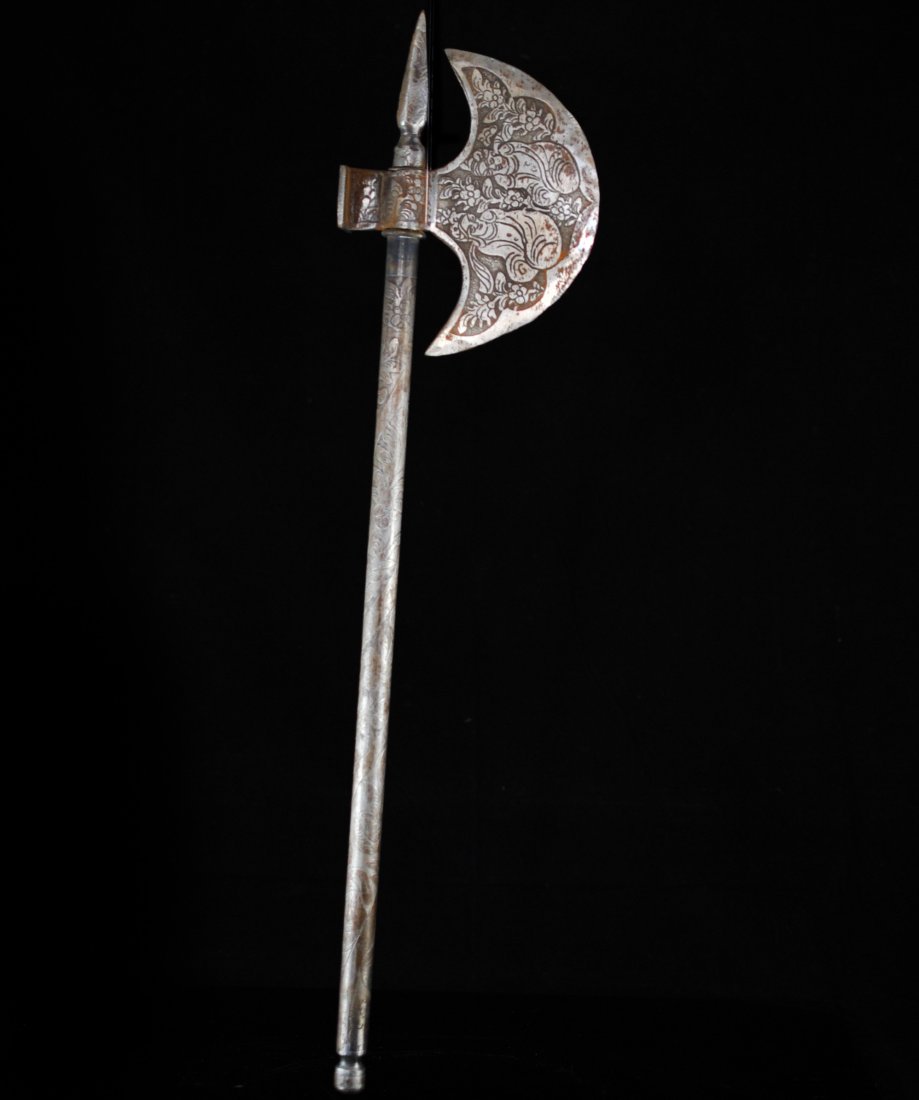 Antique Iron Persian Axe: DESCRIPTION: Iron Persian axe features large crescent blade with chiselled floral motif and a sharp pointed top. The floral design continues along the shaft, great attention to detail. CIRCA: 19th ct 