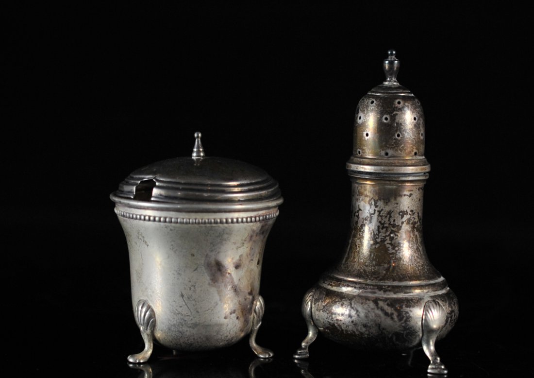 Antique Sterling Silver open Salt and Pepper Shakers: DESCRIPTION: Antique Sterling Silver Salt and pepper shakers. Salt is an open shaker with top meant for a spoon to spread salt. Both sit on a three legged base. Hallmarked Mueck-Carey Co. CIRCA: early