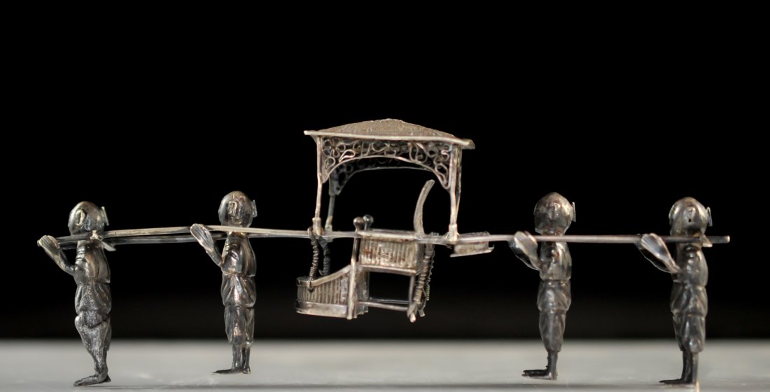 Antique Chinese 900 silver "sedan chair". Signed: DESCRIPTION: Antique Chinese 900 silver "sedan chair". Hand crafted solid silver piece featuring four men carrying an ornate silver filigree sedan chair. Great attention to detail. Hallmarked "HM 90" 