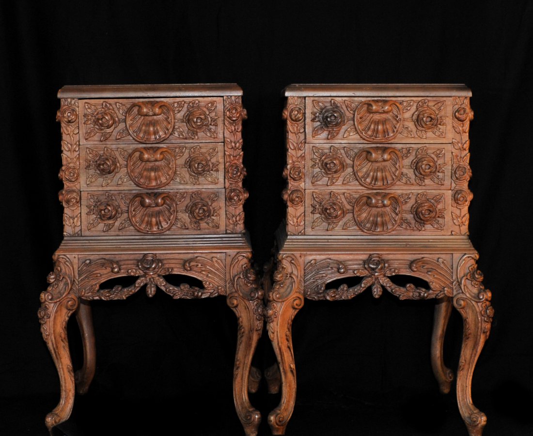 Art Nouveau Wooden Night Tables: DESCRIPTION: Pair of Mahogany hand carved Art Nouveau night tables sitting atop four legs. Features three drawers with floral hand carved motif design along the legs and the front of the tables. CIRCA
