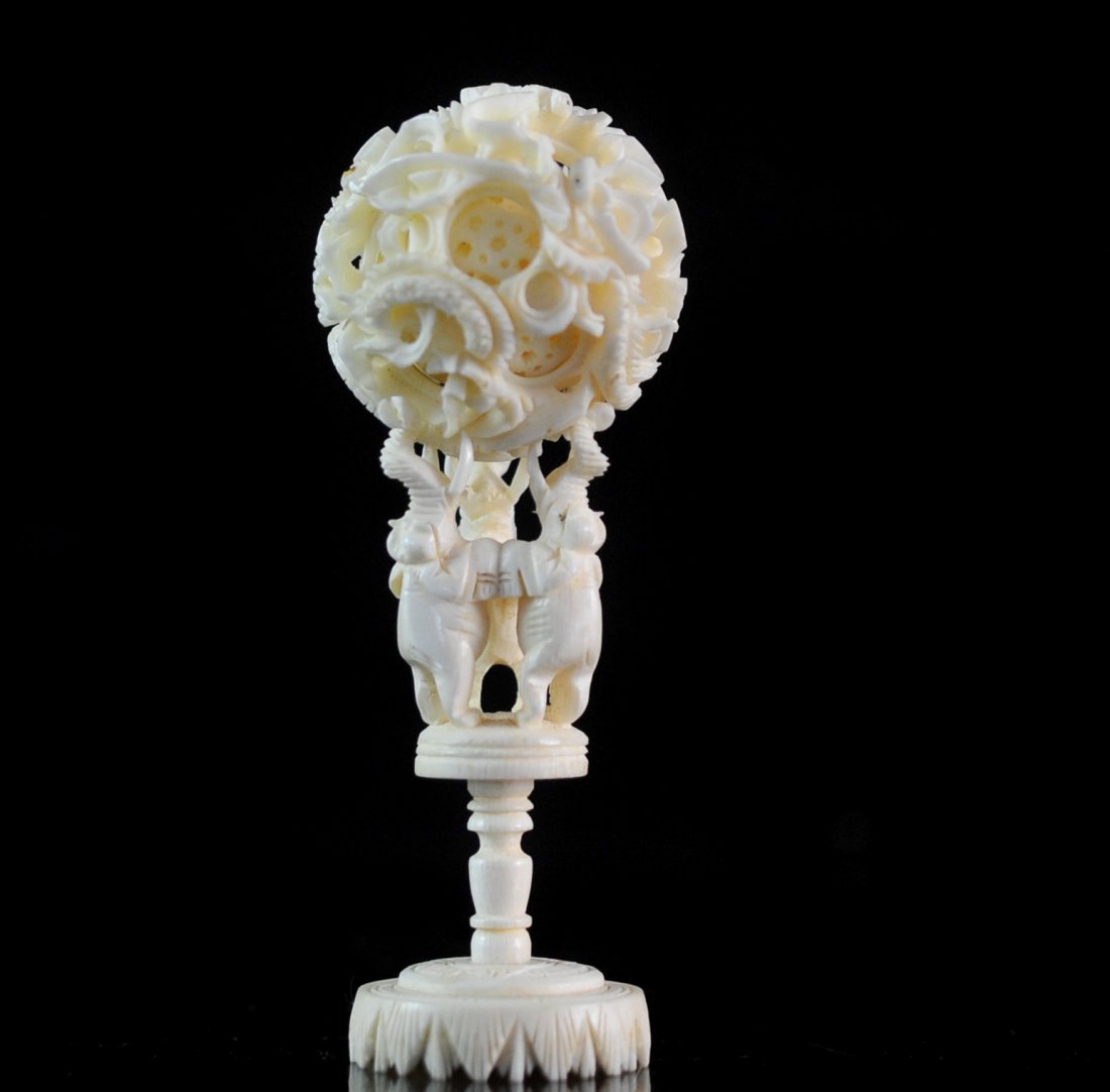 Chinese Carved Ivory Mechanical Sphere: DESCRIPTION: Hand carved ivory mechanical sphere in a dragonal and floral motif sitting on 3 elephants base with their trunks and tusks facing upward representing good luck. Very finely carved. CIRCA: