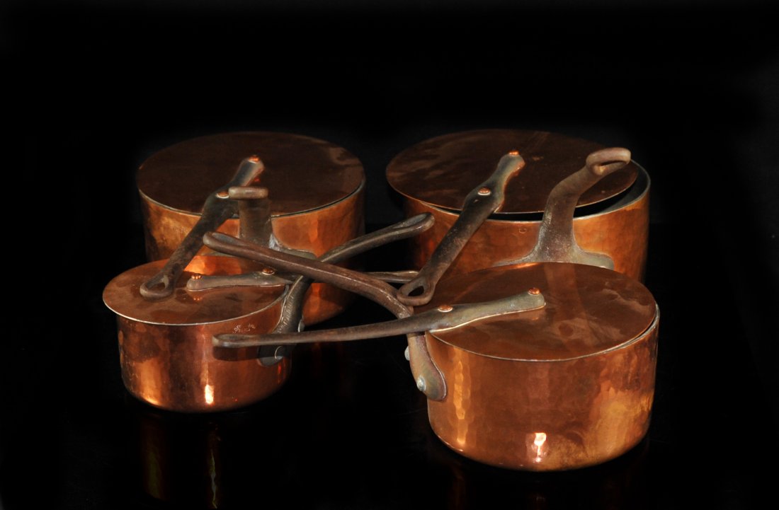 Four Antique "E.Dehillerin" Hammered Copper Pots With: DESCRIPTION: Set of four antique French hammered copper pots/saucepan with cast iron handles and accompanying pot lids made of copper with long cast iron handles.Hallmarked "E.Dehillerin Paris". CIRCA