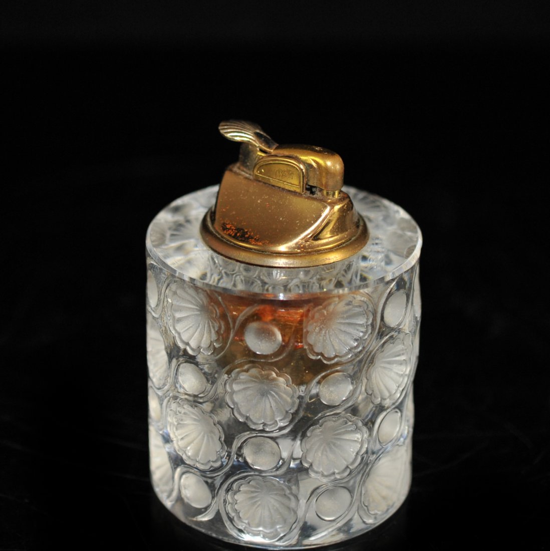 Lalique Crystal "Tokyo" Table Lighter: DESCRIPTION: Lalique crystal Tokyo lighter with frosted floral medallions along the body. Signed "Lalique France" CIRCA: 20th Ct. ORIGIN: France DIMENSIONS: H: 4" W: 3"