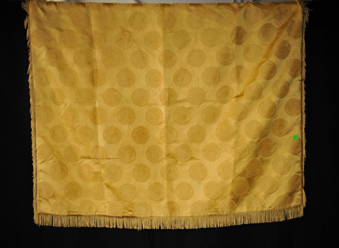 Versace Gold Tassled Throw: DESCRIPTION: Versace Gold throw features the medusa head print with fringes around the edges. CIRCA: 20th Ct. ORIGIN: Italy DIMENSIONS: H: 38" L: 38"