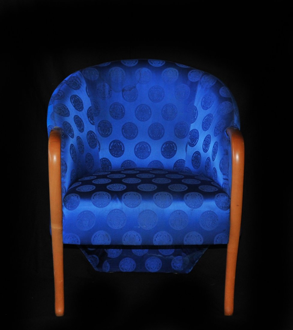 Versace Arm Chair Cobalt Blue: DESCRIPTION: Cobalt blue upholstered Versace modern arm chair with a slightly lighter cobalt blue pattern of the Medusa Insignia. CIRCA: 20th Ct. ORIGIN: Italy DIMENSIONS: H: 32.5" L: 25.7"