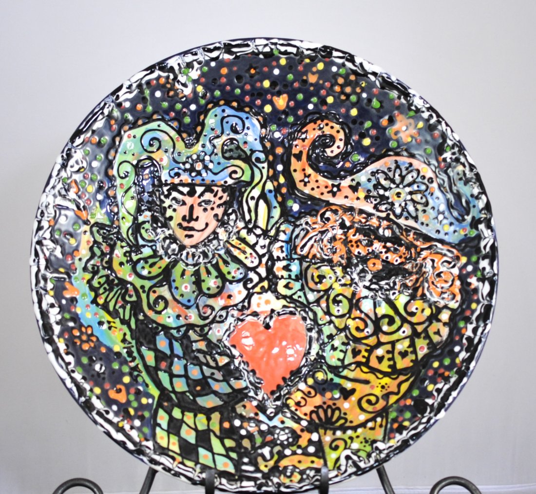 Emilio Sauma "Casmaval" Charger: DESCRIPTION: Cuban American Artist Sauma "Casmaval" features acrylic on porcelain in a fury of colors. The Glazed over charger is decorated with a jester and an array of multicolored patterns on the b