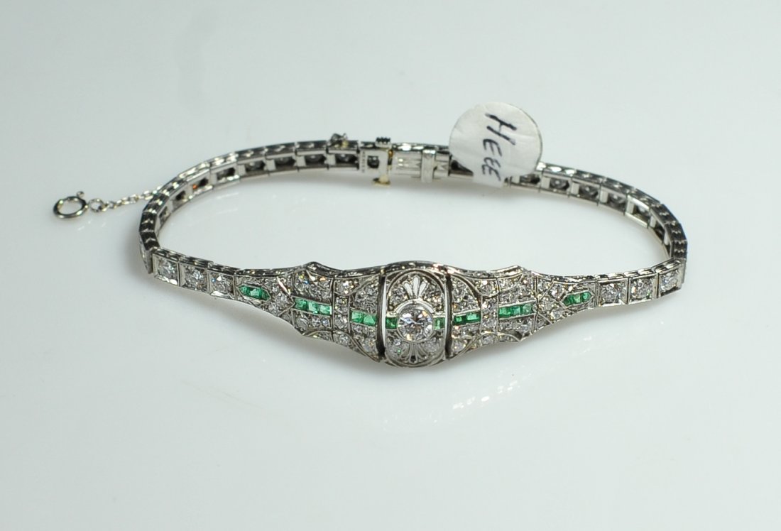Art Deco Platinum Diamond & Emerald Bracelet: DESCRIPTION: Beautiful art deco platinum bracelet with a .25 diamond on each link up to the center of the bracelet which has antique round diamonds and squared emeralds inlaid, finished with a .5 prin