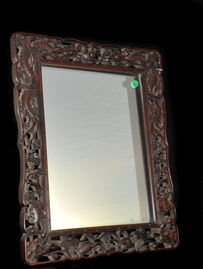 Antique Chinese Mirror, Carved Wood Frame: DESCRIPTION: Antique table mirror in a heavyily carved wooden frame with a dragonal design and a floral motif, sits up with a wooden leg that folds out. CIRCA: 19/20th ct ORIGIN: China DIMENSIONS: H:2