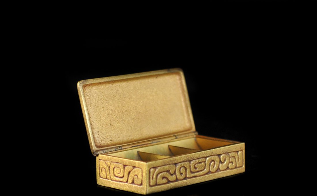 Tiffany Bronze Zodiac Stamp Box: DESCRIPTION: Tiffany bronze stamp box featuring a zodiac design on lid and side of the box. Interior includes stamp compartments. Marked "Tiffany Studios New York 802". CIRCA: 20th Ct. ORIGIN: U.S DIM