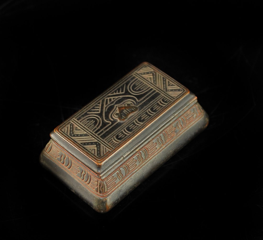 Tiffany Bronze Indian Style Stamp Box: DESCRIPTION: Tiffany bronze stamp box featuring an indian design on the lid and side of the box. Interior includes stamp compartments. Marked "Tiffany Studios New York 1184". CIRCA: 20th Ct. ORIGIN: U