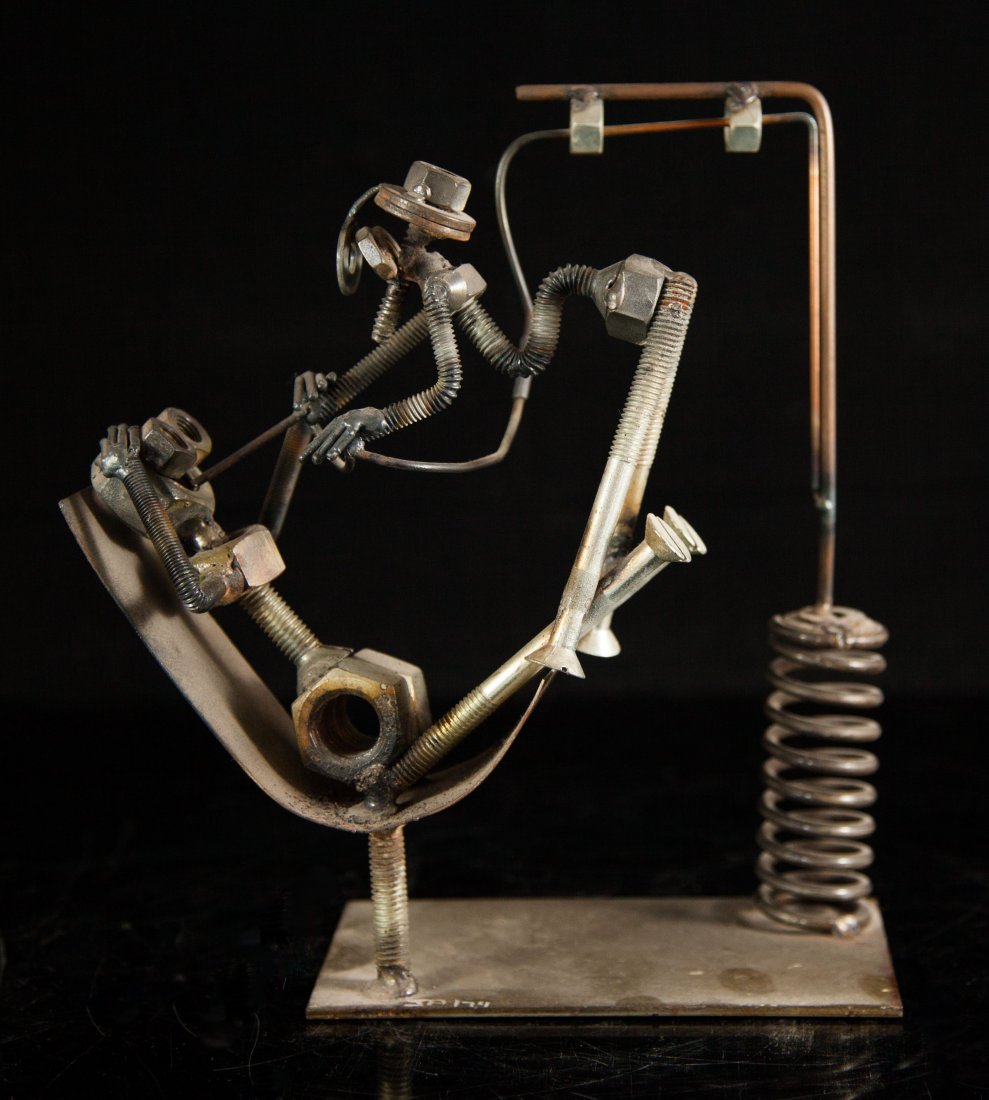 Collectors Figural Nuts & Bolts Sculpture: DESCRIPTION: Hand made collectors figural nuts and bolts sculpture welded in a dentist motif. This piece is made of metal sitting on a simple metal base signed "JA/74", well known as "Folk Art". CIRCA