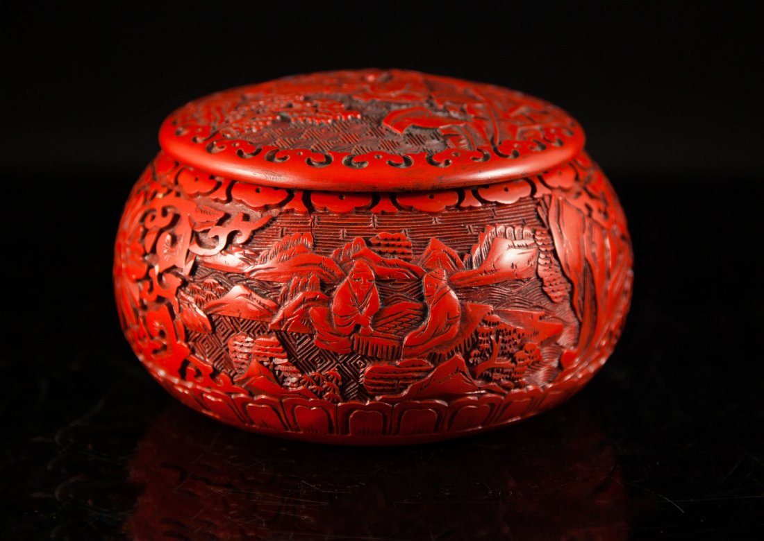 Oriental Cinnabar Lacquer Carved Lided Bowl: DESCRIPTION: A gorgeous cinnabar bowl with a lid. The entire piece has a handcarved design. On two sides is an identical scene of two figures sitting at a table, possibly playing a game. They are sitt