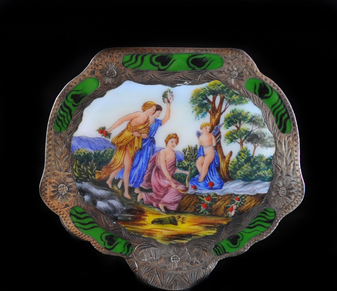 Silver Enamel Compact Case: DESCRIPTION: Silver painted enamel compact case features five green enamel borders encompassing a painted italian scene. The scene dipicts three robed woman stumbling upon a tied angel. Back of case f