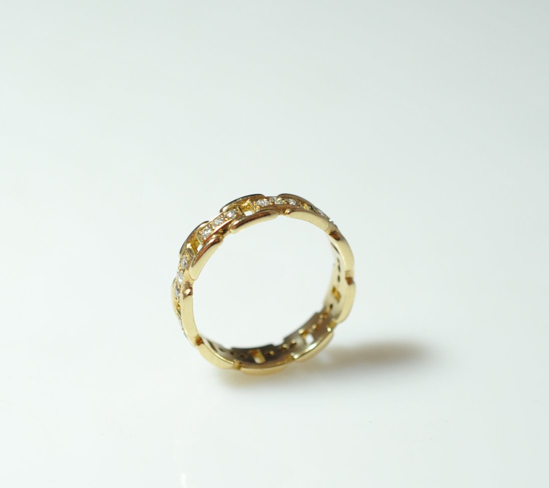 Gold & Diamond Wedding Band: DESCRIPTION: Unisex 18 karat yellow gold wedding band with 10 links where three 0.05 round cut diamonds lay in each totaling approx 1.5cts in diamonds. Marked illegibly on the interrior. Ring weighs a
