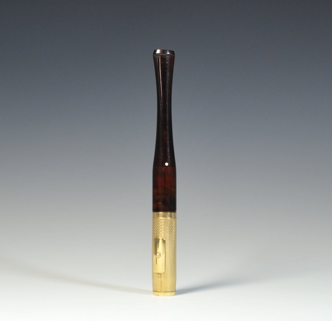 Dunhill Cigarette Holder: DESCRIPTION: Dunhill tortoise handle and 14K gold fill short-slim cigarette holder with an ejector clasp. Marked on the stem of the goldfill "Denicotea" "No-14KG.F." "Dunhill". CIRCA: 20th ct ORIGIN: