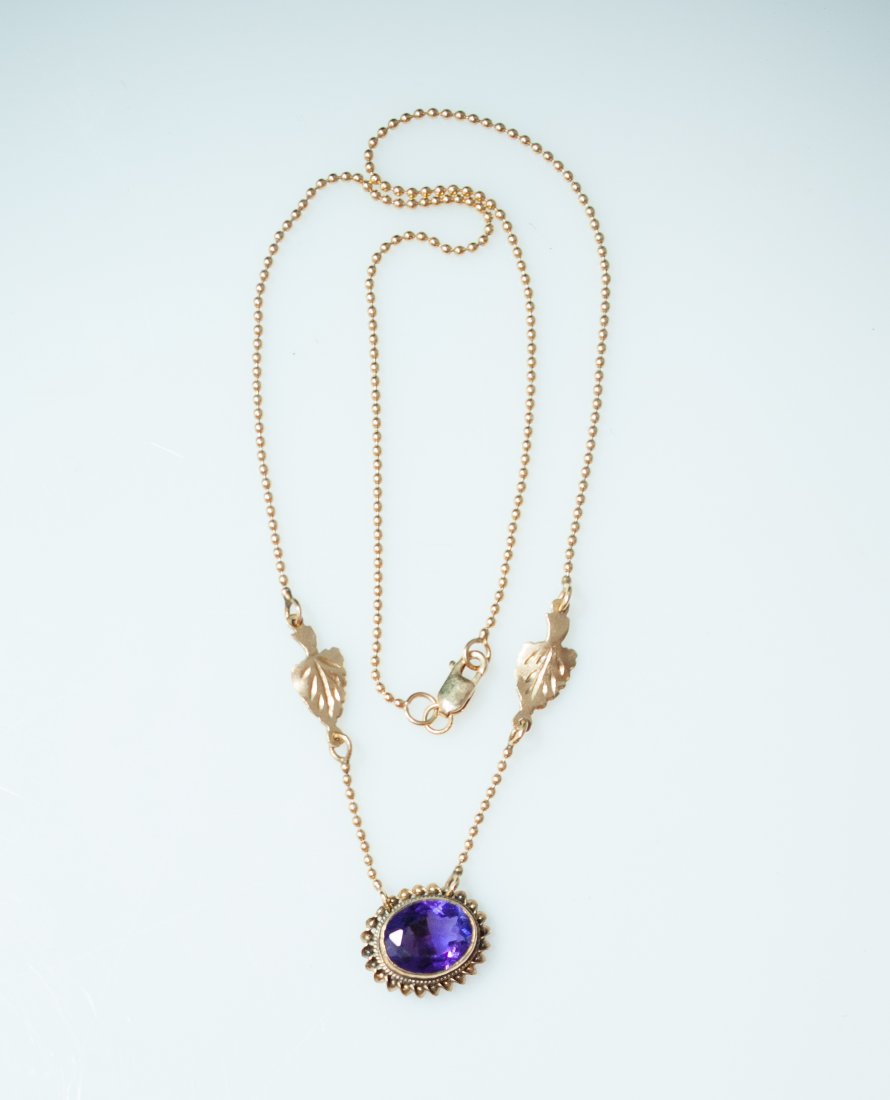 Gold & Amethyst Necklace: DESCRIPTION: 14k gold beaded chain features a beautiful oval cut amethyst stone placed carefully in a gold pendant. 4.4 grams CIRCA: Late 20th Ct. ORIGIN: Italy DIMENSIONS: L: 16" (2.8 dwt)