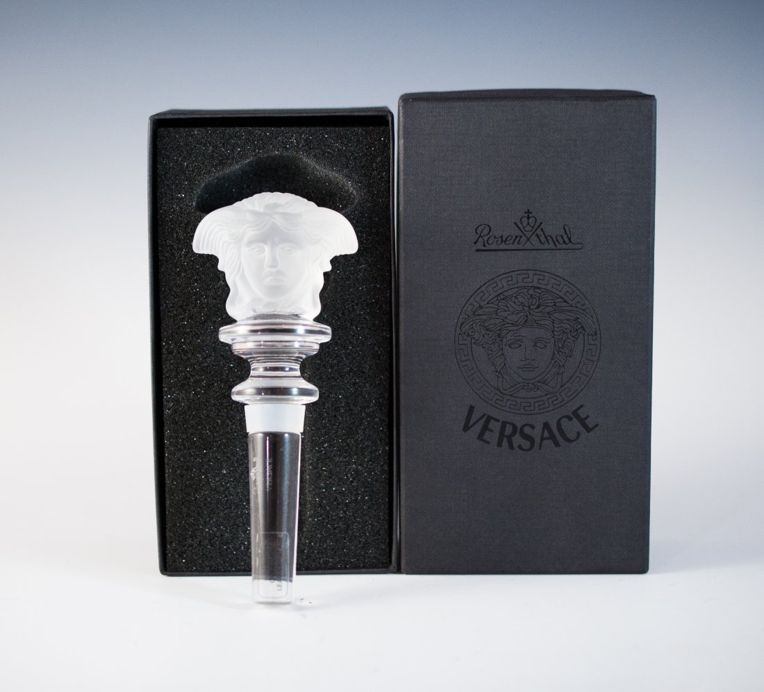 Versace Crystal Stopper: DESCRIPTION: The House of Versace's signature Medusa design is crafted in frosted glass and sits upon a faceted crystal stopper. Includes original box and packaging. CIRCA: Late 20th Ct. ORIGIN: Italy