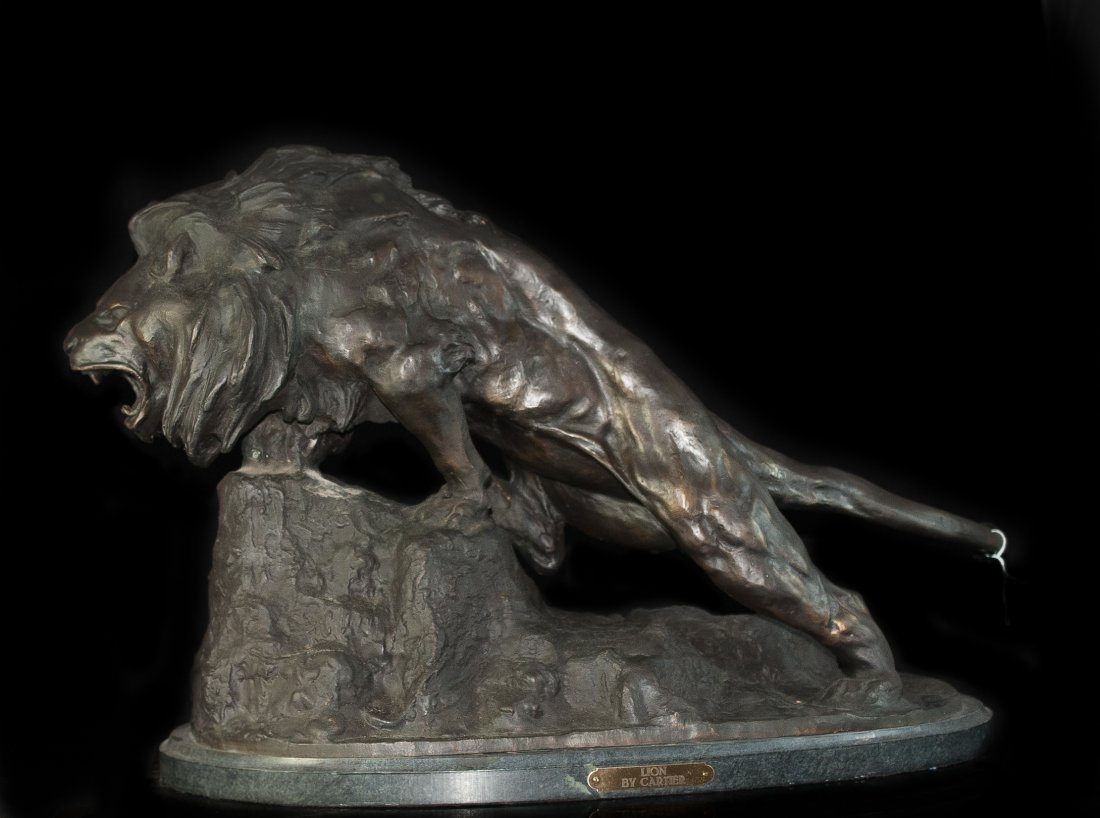 Large Spelter Lion: DESCRIPTION: Large Spelter lion, after Thomas Francois Cartier features a beautiful rich dark brown patina with excellent details accentuating the feline features. The lion stands at the peak of a roc