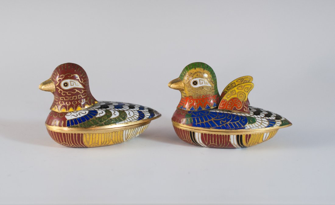 Chinese Cloisonne Ducks: DESCRIPTION: Pair of chinese cloisonne ducks feature a multi colored design with removable tops. Interior reveals a cobalt blue color. CIRCA: Mid 20th Ct. ORIGIN: China DIMENSIONS: H: 2" L: 3"