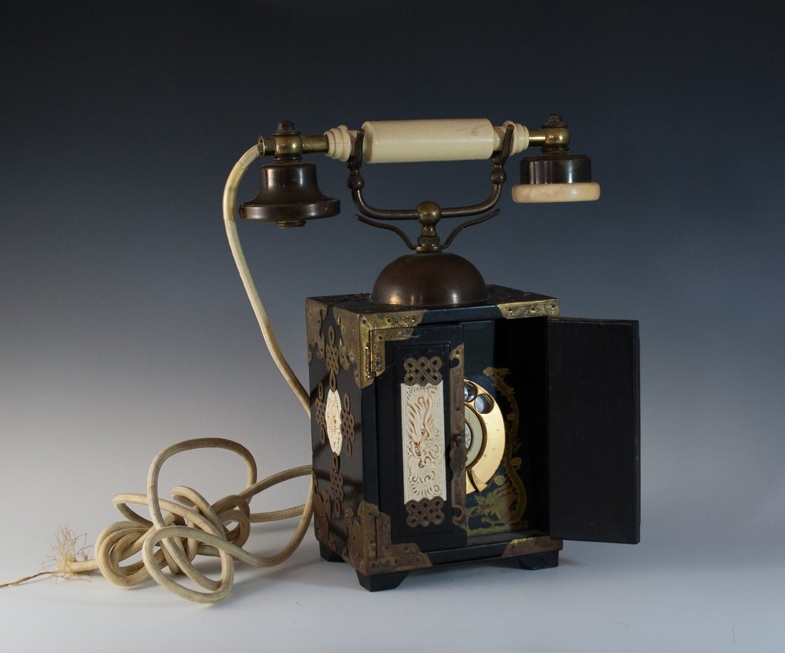 Chinese Rotary Telephone: DESCRIPTION: Chinese Intercontinental Telephone Co. rotary telephone "dated 1966" made from a converted wood and ivory jewelry box. The phone is decorated with engraved brass ornaments and finely carv