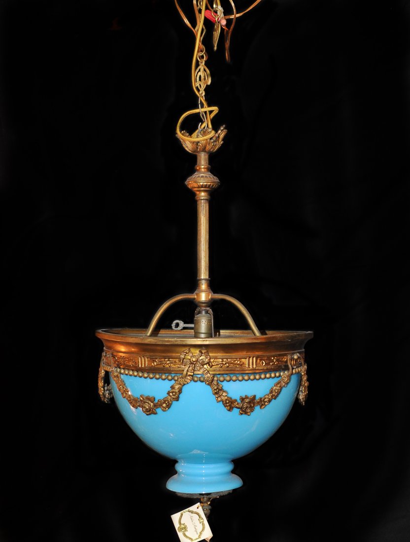 Bronze & Opaline Glass Chandelier: DESCRIPTION: Bronze chandelier features ornate design which overlays on a turquoise opaline glass. The bottom of the glass is finished off by a bronze tip. CIRCA: Mid 20th Ct. ORIGIN: France DIMENSION