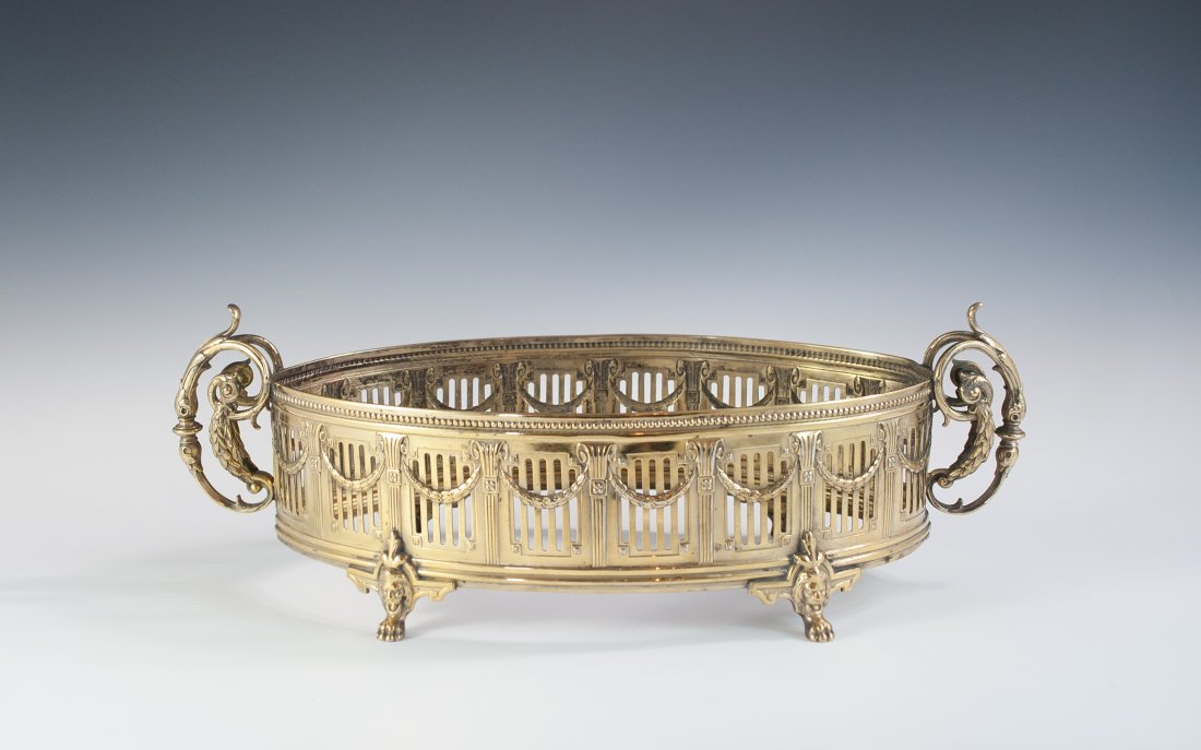 WMF Silver Center Piece: DESCRIPTION: Silver plated gilded WMF center piece features a beautiful peirced design along the body and finished off with two figural handles decorated with wings and vines. The center piece stands 