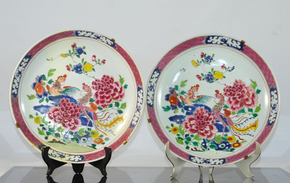 Famille Rose Porcelain Chargers: DESCRIPTION: Pair of famille rose multi colored porcelain Chinese wall hanging chargers with an uplifting floral and bird motif and decorative trim. One of them has been repaired. CIRCA: 19th ct ORIGI